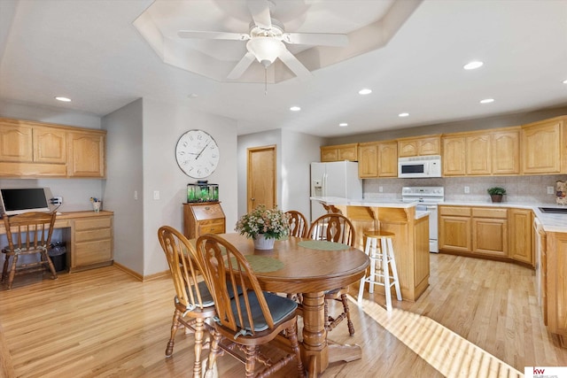 dining room featuring light wood-type flooring, built in study area, ceiling fan, and recessed lighting