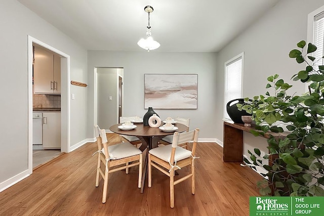 dining room with baseboards and light wood finished floors