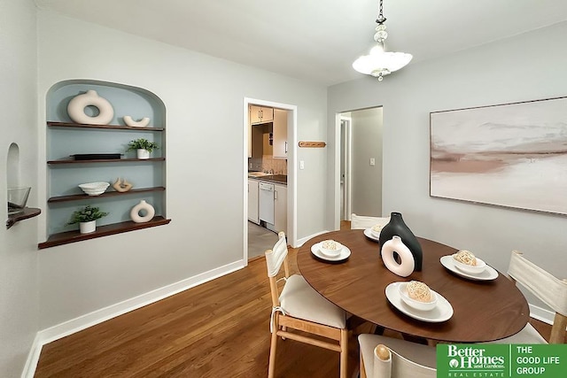 dining room with baseboards and wood finished floors