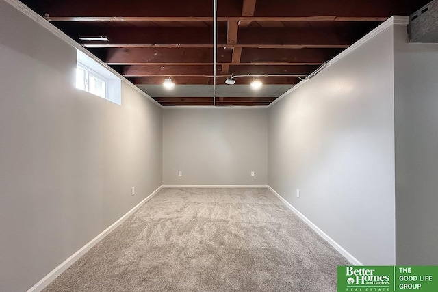 below grade area featuring carpet floors and baseboards