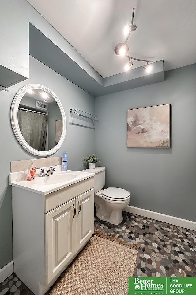 full bath featuring toilet, baseboards, and vanity