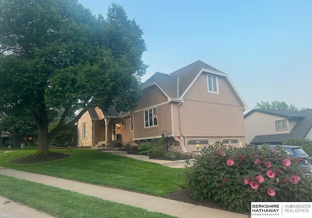 view of side of home with a garage and a lawn