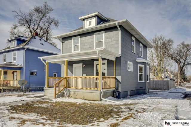 american foursquare style home featuring covered porch