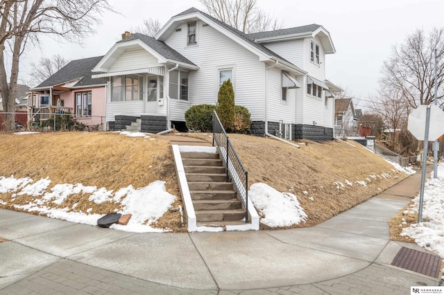 bungalow-style house with a shingled roof