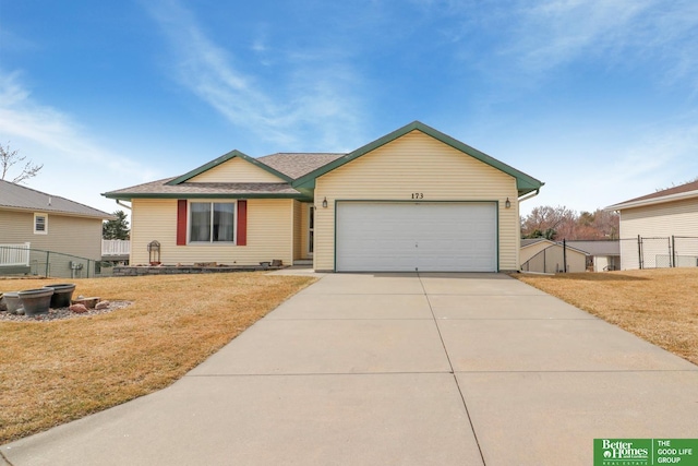 single story home featuring an attached garage, concrete driveway, a front lawn, and fence