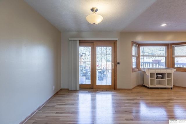 doorway to outside with light wood-style flooring, baseboards, and recessed lighting