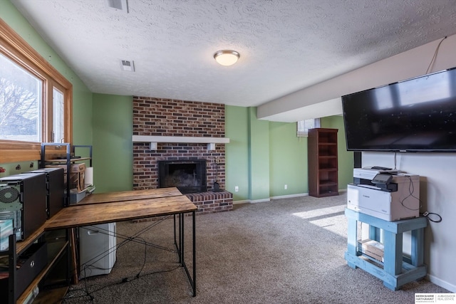 living area with a textured ceiling, carpet floors, a fireplace, and baseboards