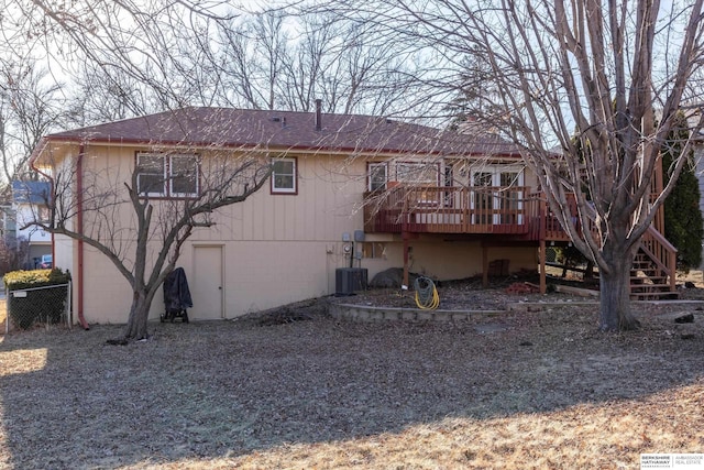 rear view of house with roof with shingles, stairs, fence, a deck, and cooling unit