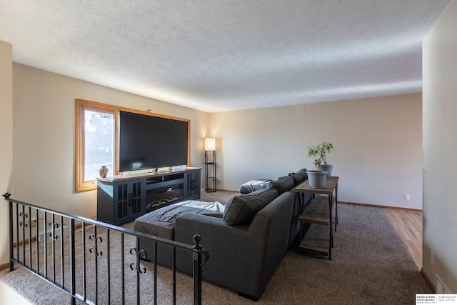 living area featuring baseboards and a textured ceiling