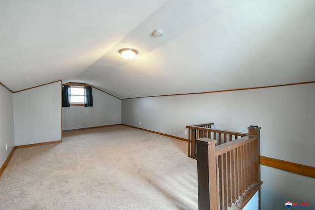 additional living space featuring lofted ceiling, baseboards, and carpet floors