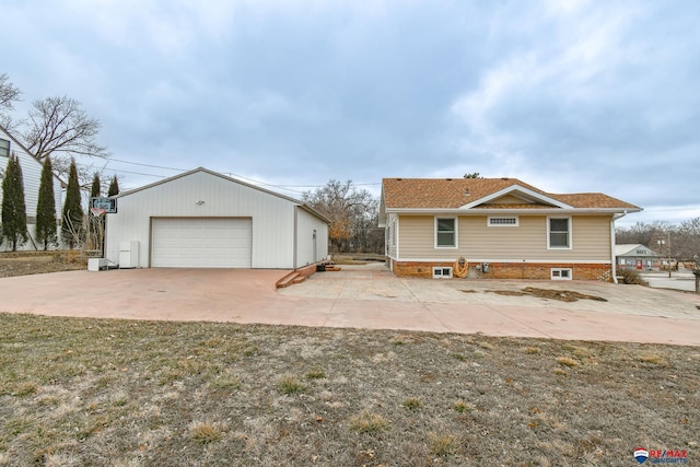 view of front facade featuring a garage and an outdoor structure