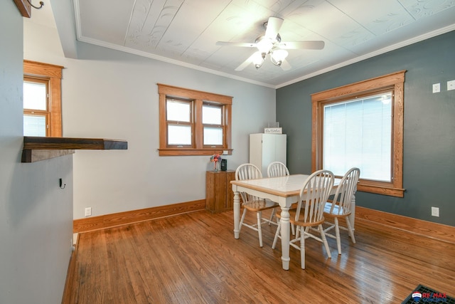 dining room with baseboards, wood finished floors, and a healthy amount of sunlight