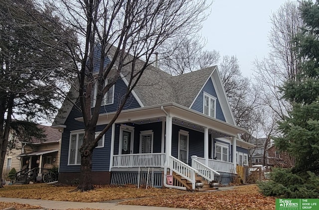 view of front of property with a porch and roof with shingles