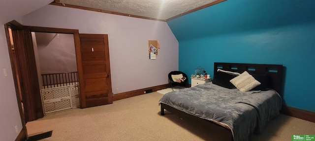 carpeted bedroom with baseboards, vaulted ceiling, and a textured ceiling