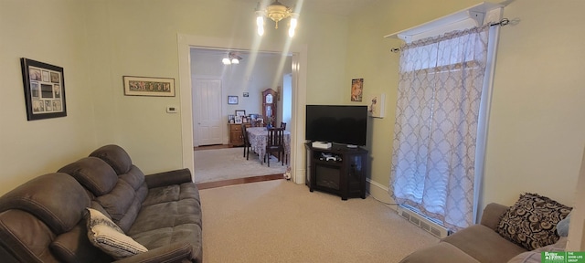 living area featuring visible vents and light colored carpet