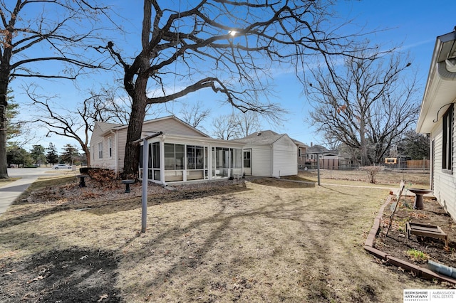 exterior space featuring fence and a sunroom