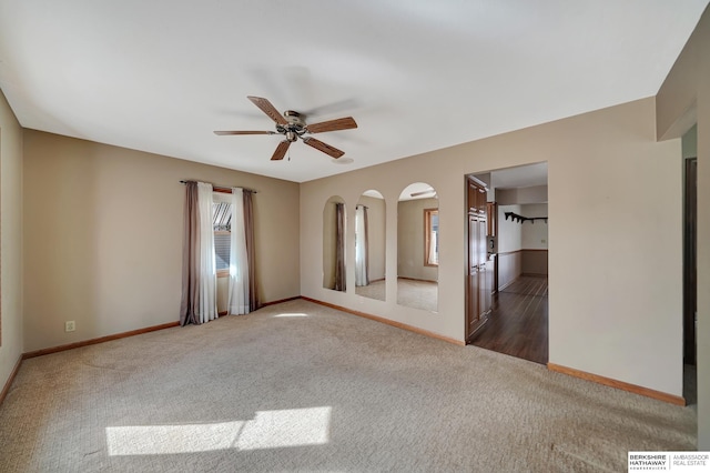 spare room with visible vents, baseboards, carpet, and a ceiling fan