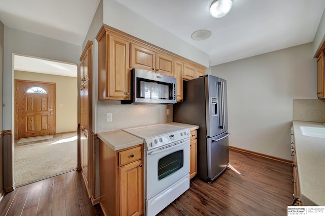 kitchen featuring tasteful backsplash, baseboards, light countertops, appliances with stainless steel finishes, and dark wood-style floors