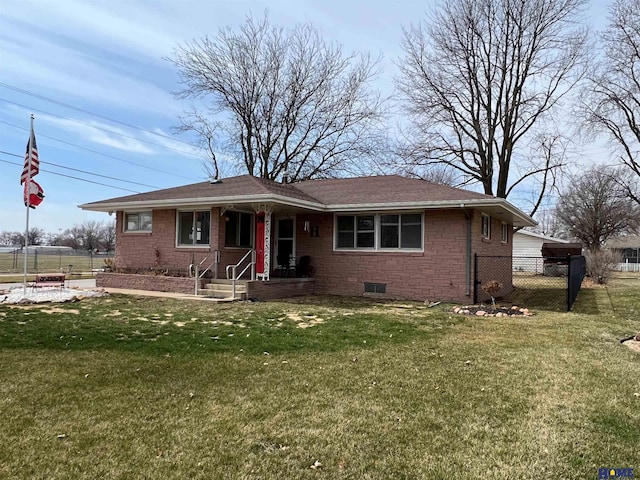 view of front of home with brick siding, fence, and a front yard