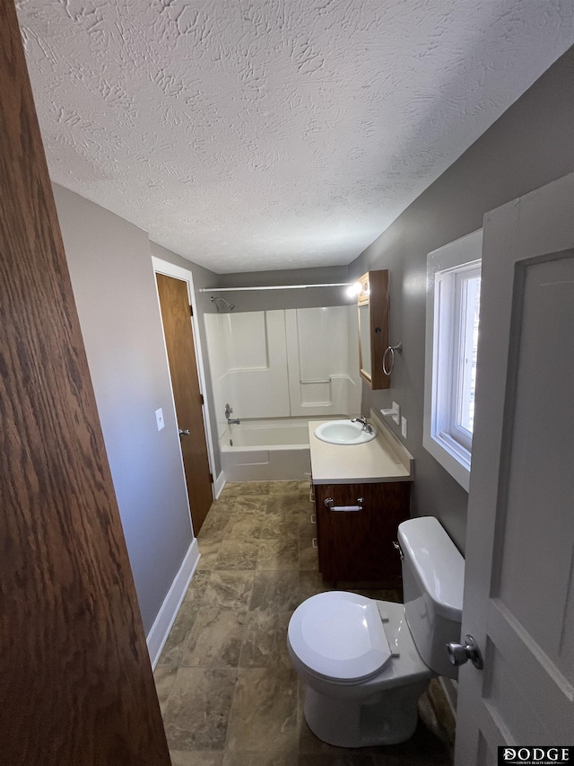 full bath with baseboards, toilet,  shower combination, a textured ceiling, and vanity