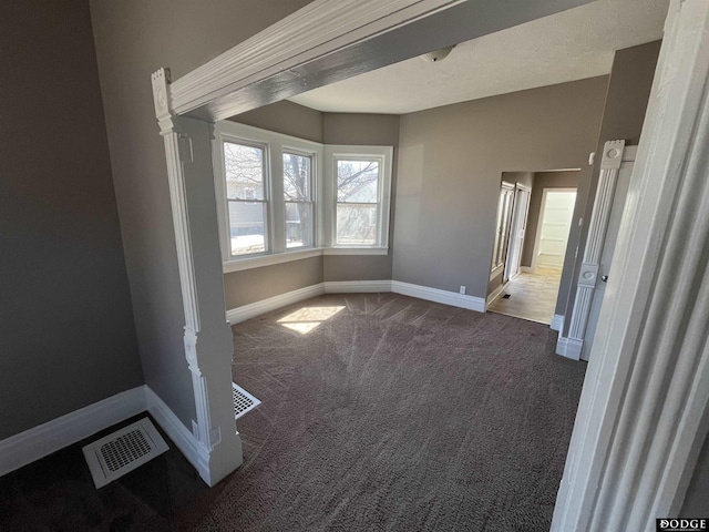 unfurnished bedroom with baseboards, visible vents, and carpet flooring