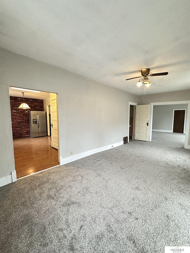 spare room featuring baseboards and carpet flooring