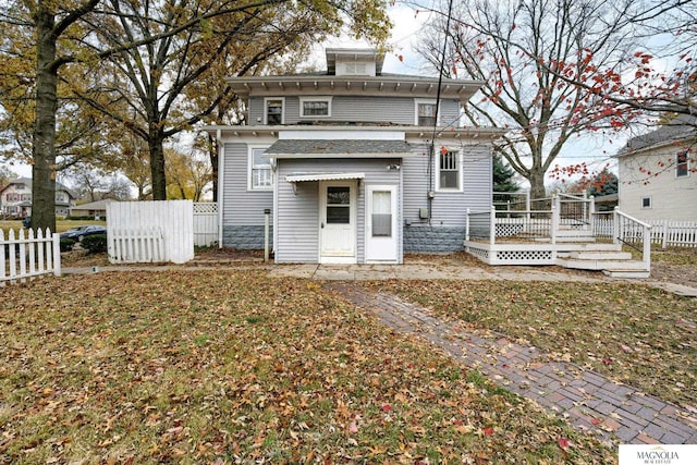 rear view of property featuring fence and a wooden deck