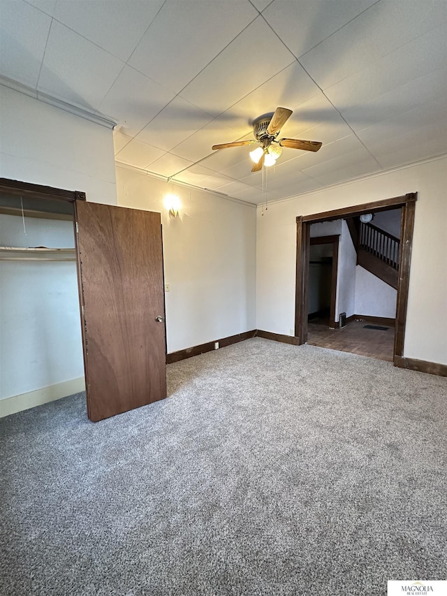 unfurnished bedroom featuring carpet floors, ceiling fan, and baseboards