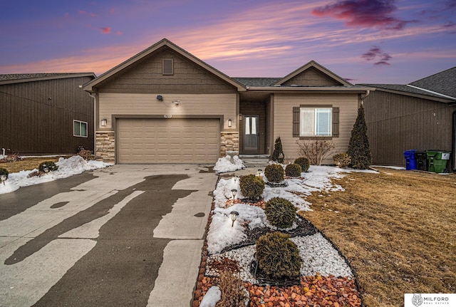 view of front facade with a garage, stone siding, and driveway