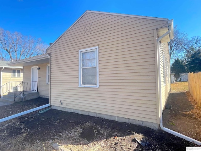 view of side of property featuring fence