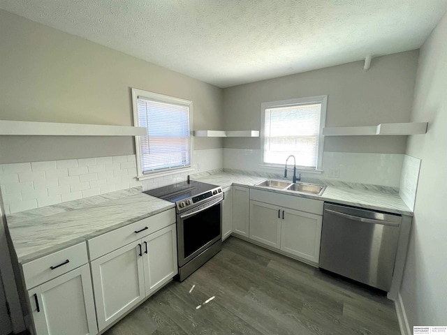 kitchen with stainless steel appliances, dark wood-type flooring, a sink, white cabinets, and open shelves