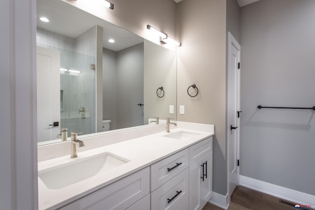 full bathroom with a shower stall, toilet, baseboards, and a sink