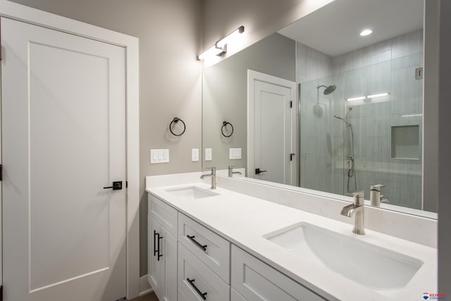 full bathroom featuring a sink, recessed lighting, a stall shower, and double vanity