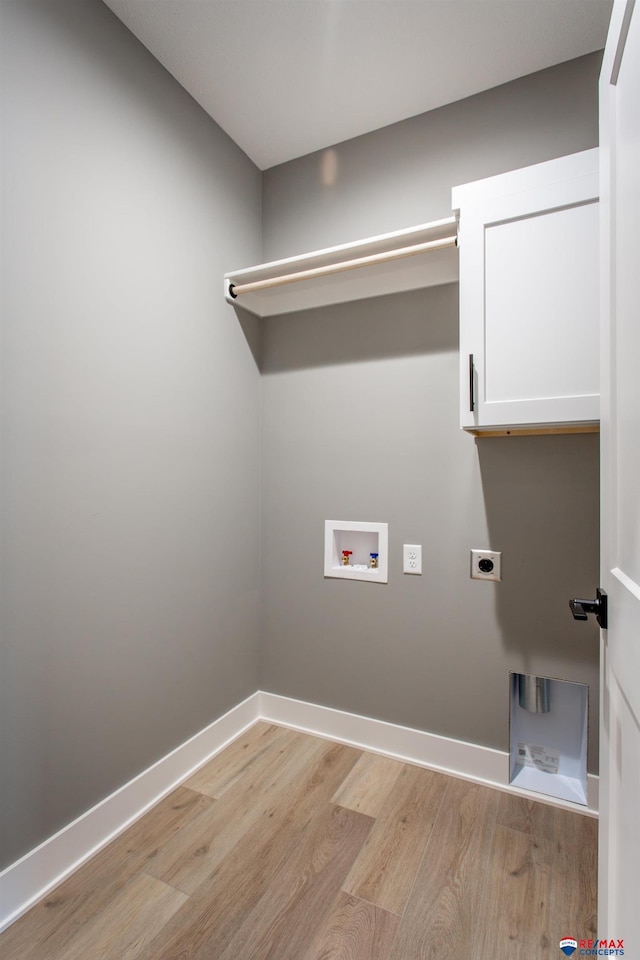 laundry room with baseboards, hookup for an electric dryer, light wood-style flooring, cabinet space, and washer hookup