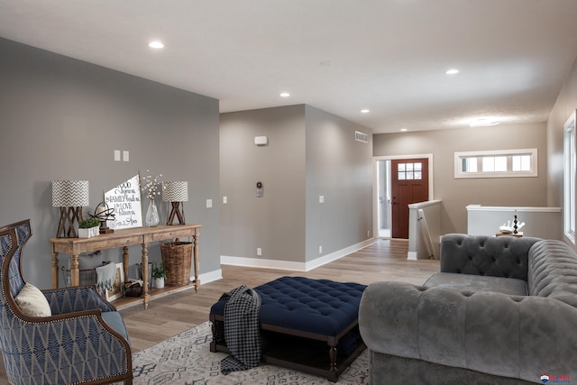 living room featuring recessed lighting, light wood-style floors, visible vents, and baseboards