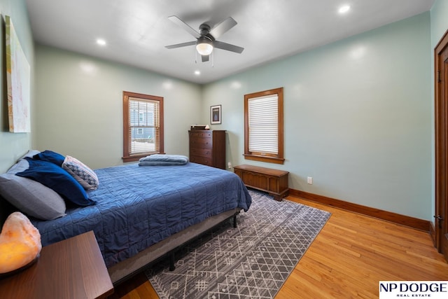 bedroom with recessed lighting, wood finished floors, and baseboards