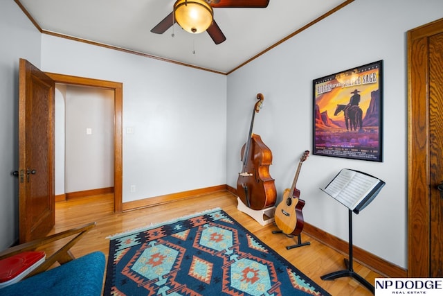 interior space with baseboards, light wood-style flooring, and crown molding