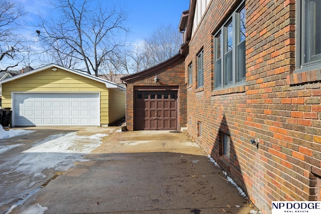 view of home's exterior with brick siding and an outbuilding