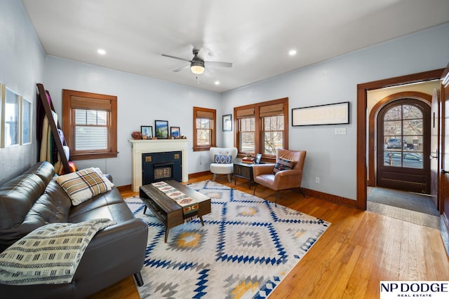 living area with baseboards, recessed lighting, a fireplace, a ceiling fan, and wood-type flooring