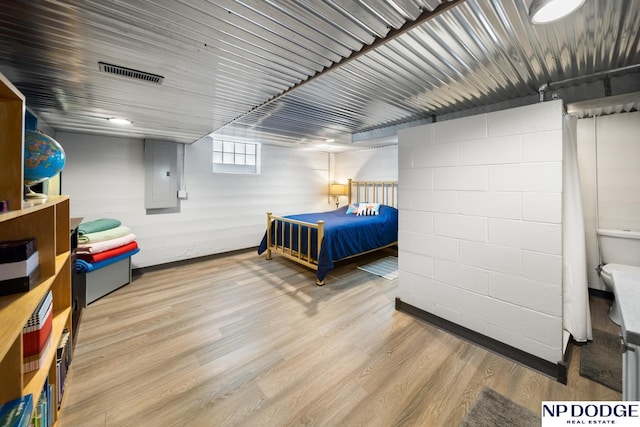 bedroom featuring visible vents and wood finished floors