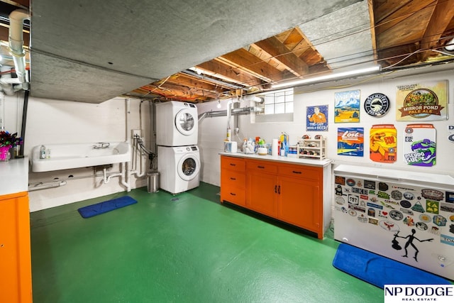 below grade area with stacked washing maching and dryer and a sink