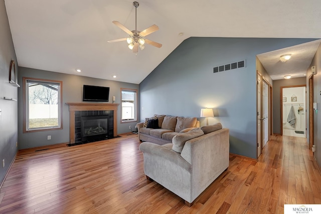 living room featuring a wealth of natural light, visible vents, and light wood finished floors