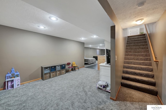 recreation room with carpet flooring, recessed lighting, baseboards, and a textured ceiling