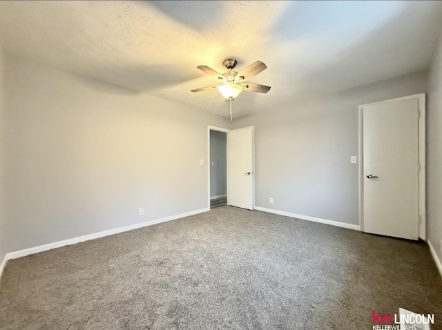 carpeted empty room featuring ceiling fan and baseboards