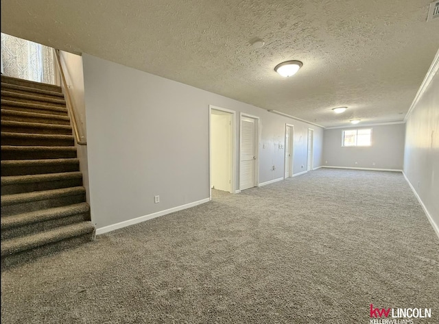 basement with baseboards, stairway, ornamental molding, a textured ceiling, and carpet flooring