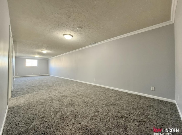 spare room with a textured ceiling, visible vents, baseboards, ornamental molding, and carpet