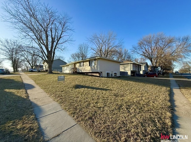 view of home's exterior with a yard