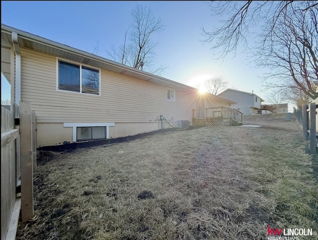 rear view of property with fence and central AC