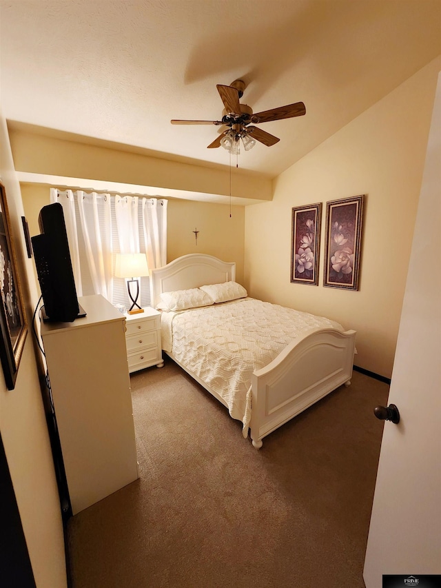 carpeted bedroom with vaulted ceiling and a ceiling fan