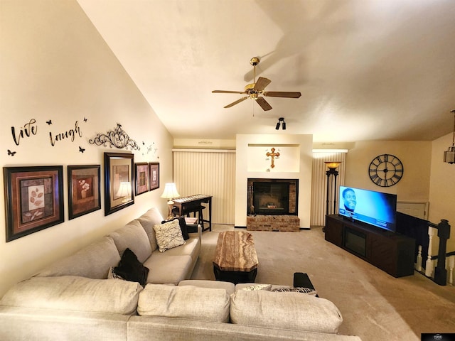 living area featuring ceiling fan, carpet floors, and a brick fireplace